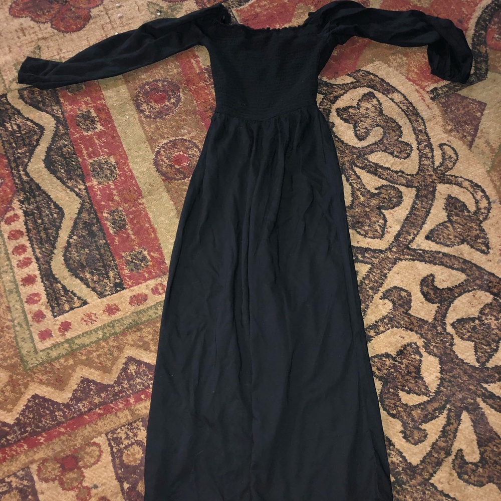 a black jumpsuit with a ruffled-like top half
